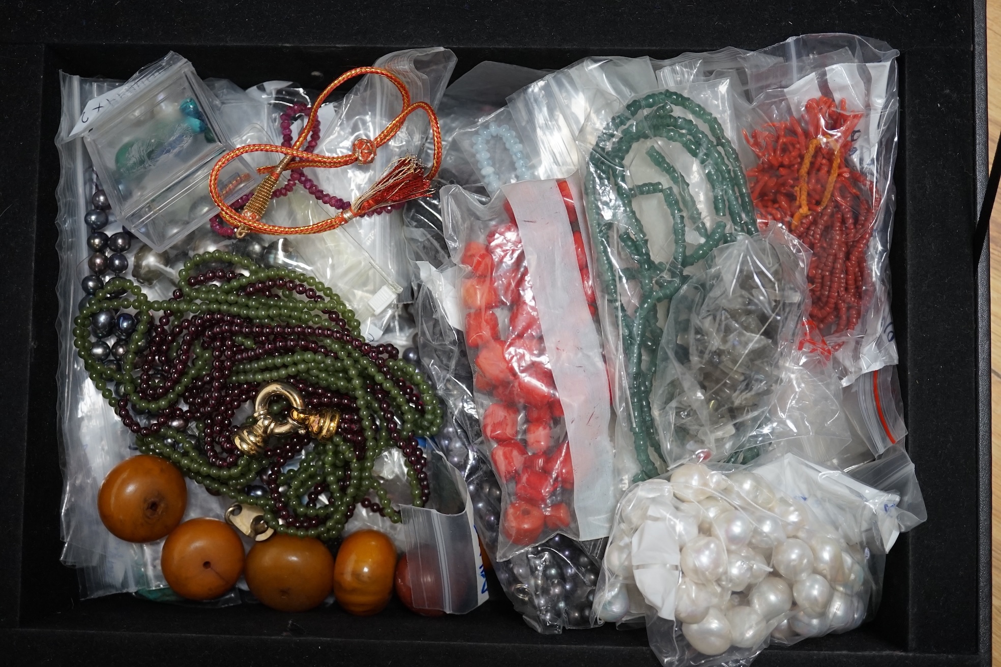 A large collection of bead necklaces and unmounted turquoise and baroque pearls. Condition - fair